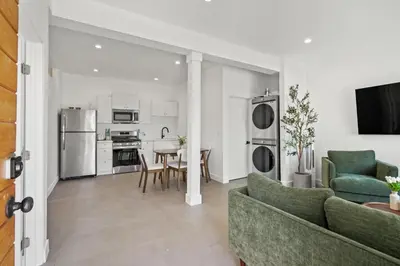 a living room with a couch and a table at Private Cozy Guest House, King Bed, Parking, Pet Friendly near Penmar Golf Course! in Los Angeles