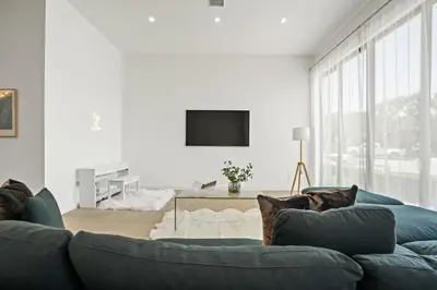 a living room with a couch with a dog laying on it at New Lavish Elegant 3BR Home in Mar Vista, Pet Friendly! 10min to Venice Beach! in Los Angeles