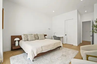 a white bedroom with a bed and a chair at New Lavish Elegant 3BR Home in Mar Vista, Pet Friendly! 10min to Venice Beach! in Los Angeles