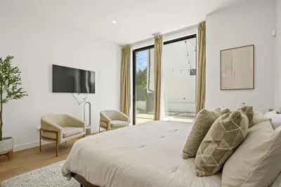 a white bedroom with a bed and a large window at New Lavish Elegant 3BR Home in Mar Vista, Pet Friendly! 10min to Venice Beach! in Los Angeles