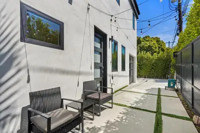 a group of chairs sitting on the side of a building at Scandinavian 2BR, 2Bath Townhome, Pet & Kid Friendly, Free Parking, 10min to Venice Beach! in Los Angeles