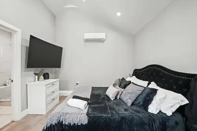 a bedroom with a bed with a television on it at New Modern Cozy Guest House, Parking, Pet Friendly in Mar Vista! in Los Angeles