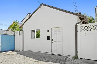 a white garage with a white door and a gate at New Modern Cozy Guest House, Parking, Pet Friendly in Mar Vista! in Los Angeles