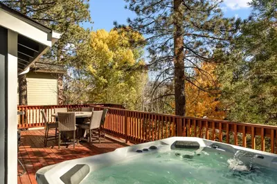 a hot tub on the deck of a house at Lakeside Paradise Escape in Big Bear Lake