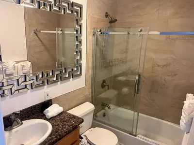 a bathroom with a shower and a toilet and a sink at An Amazing comfortable home front middle unit 1q bed and other room with sofa in Los Angeles