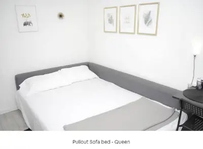 a white bed in a room with a table at 2 Miles to Disneyland -FREE Parking! In Anaheim CA in Anaheim