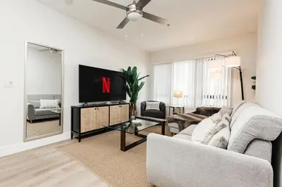 a living room with a couch and a tv at Central Quality 2 BD Apartment in Los Angeles