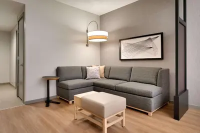 a living room with a couch and a table at Hyatt Place at Anaheim Resort / Convention Center in Anaheim