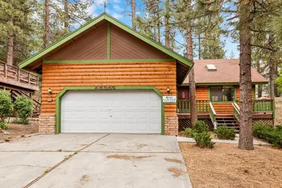 a wooden house with a garage in front of it at Pines and needles #1454 in Big Bear Lake
