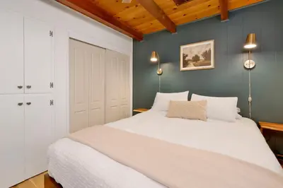 a bedroom with a white bed and blue walls at Cozy fox #2035 in Big Bear Lake