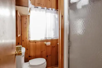 a bathroom with a toilet and a window at Pine nest#2296 in Big Bear Lake