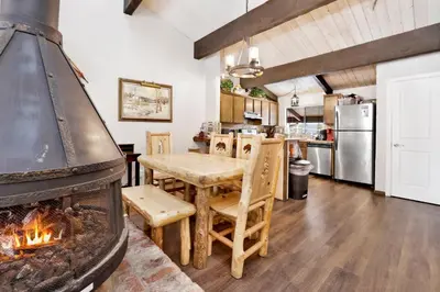a kitchen and dining room with a large fireplace at Smith summit chalet #2461 in Big Bear Lake