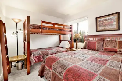 a bedroom with two bunk beds and a window at Smith summit chalet #2461 in Big Bear Lake