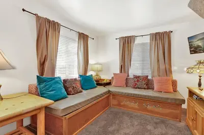 a living room with a couch with colorful pillows at Life of riley #1608 in Big Bear Lake