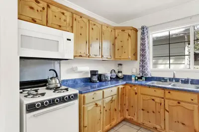 a kitchen with wooden cabinets and a stove top oven at Life of riley #1608 in Big Bear Lake