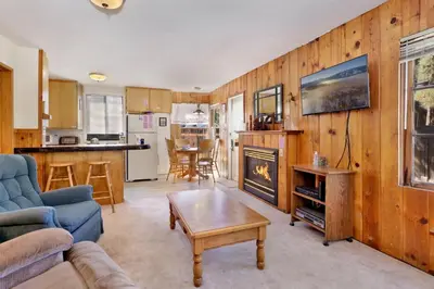a living room with a couch a table and a fireplace at JUS' RESTIN #265 in Big Bear Lake