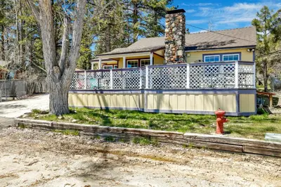 a house with a white fence and a fire hydrant at FRANK'S OLD BEAR #149 in Big Bear Lake