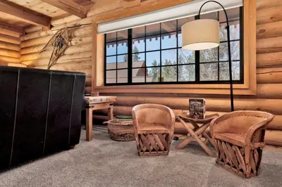 a living room with a table and chairs and a window at Woodland log #1887 in Big Bear Lake