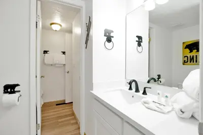 a white bathroom with a sink and a mirror at Chairlift lodge#2354 in Big Bear Lake