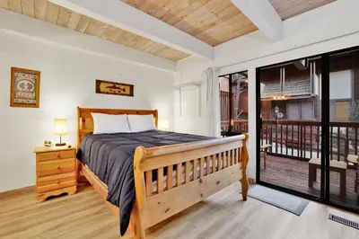 a bedroom with a bed and a balcony at Chairlift lodge#2354 in Big Bear Lake