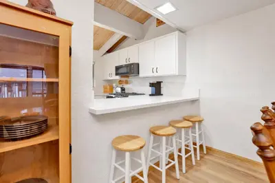 a kitchen with a counter and stools in a room at Chairlift lodge#2354 in Big Bear Lake