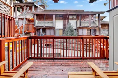 a deck with two chairs and a house at Chairlift lodge#2354 in Big Bear Lake