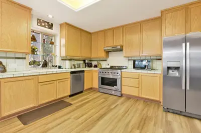 a large kitchen with wooden cabinets and stainless steel appliances at CAN'T BEAR TO LEAVE #1156 in Big Bear Lake