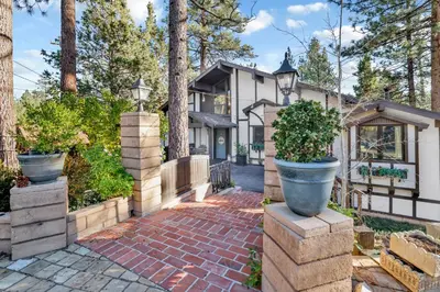 a home with potted plants and a brick driveway at Soaring pines #2193 in Big Bear Lake