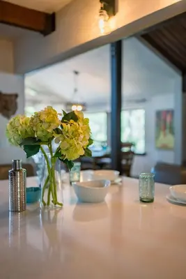 a vase of yellow flowers sitting on a table at Soaring pines #2193 in Big Bear Lake