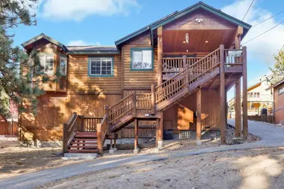 a log house with stairs leading up to it at River rock lodge #1953 in Big Bear Lake
