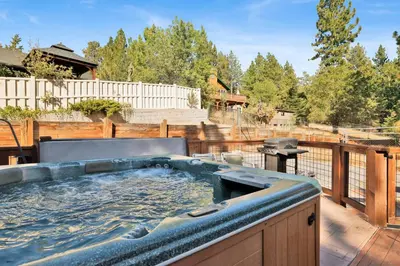 a hot tub on the deck of a backyard at River rock lodge #1953 in Big Bear Lake
