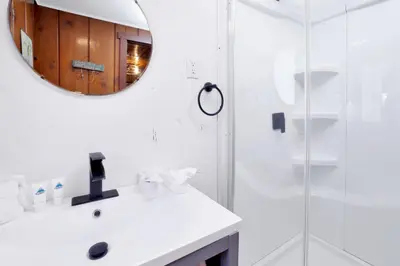 a white bathroom with a sink and a mirror at Big pines #103 in Big Bear Lake