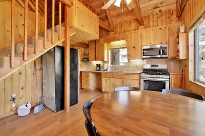 a kitchen with a table and chairs in a cabin at Fawnskin pines #2259 in Fawnskin