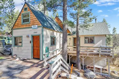 a tiny house in the woods with a porch at Fawnskin pines #2259 in Fawnskin