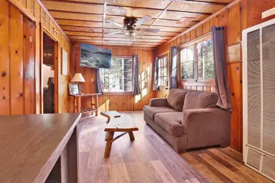 a living room with a couch and a table at Little pines #102 in Big Bear Lake