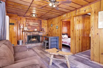 a living room with a couch and a fireplace at Little pines #102 in Big Bear Lake