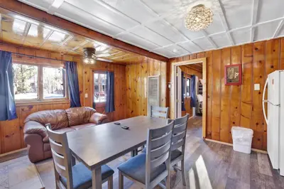 a dining room with a table and a couch at Lakeview #104 in Big Bear Lake