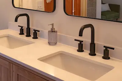 a bathroom sink with four faucets and a mirror at The lost compass #2165 in Big Bear Lake