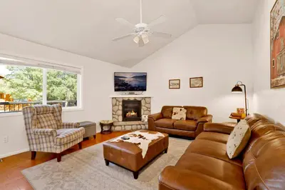 a living room with leather furniture and a fireplace at Mountain modern #1743 in Big Bear Lake