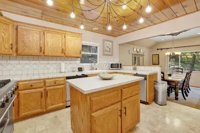 a large kitchen with wooden cabinets and a dining room at Knickerbocker retreat #2321 in Big Bear Lake
