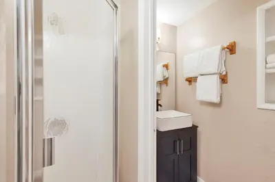 a bathroom with a sink and a shower with towels at Lake shore #012 in Big Bear Lake