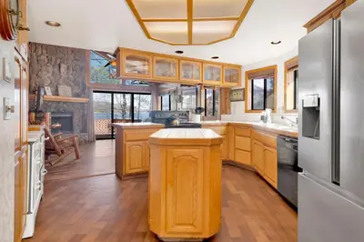 a kitchen with wooden cabinets and a stainless steel refrigerator at Lake shore #012 in Big Bear Lake