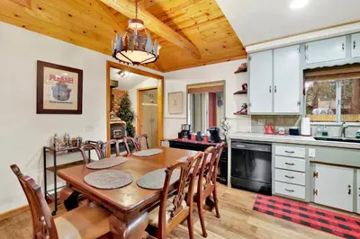 a kitchen and dining room with a wooden table and chairs at Timber pines chalet #2417 in Big Bear Lake