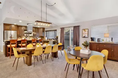 a kitchen and dining room with yellow chairs and tables at Majestic sky retreat #2090 in Big Bear Lake