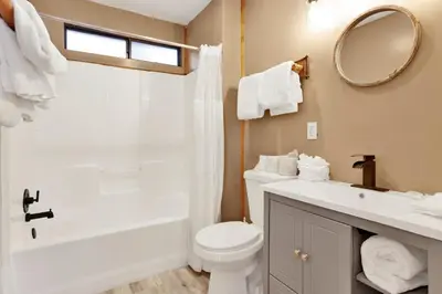 a bathroom with a toilet and a sink and a mirror at Lonepine#107 in Big Bear Lake