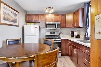 a kitchen with a table and a white refrigerator at Lonepine#107 in Big Bear Lake