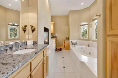 a bathroom with two sinks and a bath tub and a tubermott at Sunset ridge villa #2178 in Big Bear Lake