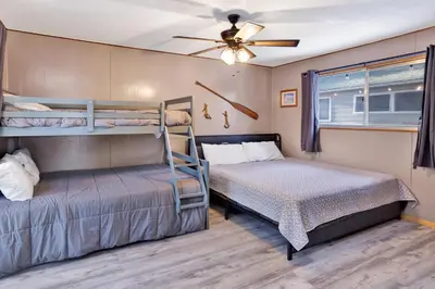 a bedroom with two bunk beds and a ceiling fan at Lakefront #110 in Big Bear Lake
