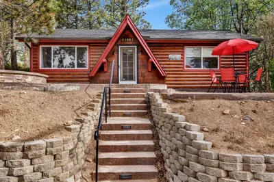 a log cabin with stairs leading to the front door at Moulin rouge #2055 in Big Bear Lake