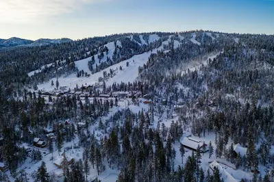 an aerial view of a snow covered mountain with trees at Ski time getaway #1848 in Big Bear Lake